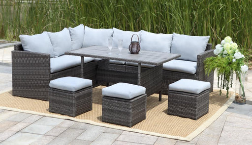 A lifestyle image of Ramoche's 7 piece rattan outdoor dining set in grey, in a garden